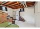 Unfinished basement with carpeted floor, white walls and exposed wood beams, offers ample storage space at 2251 Braun Dr, Golden, CO 80401
