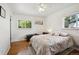 Bright bedroom with hardwood floors, ceiling fan, and sun-filled windows, creating a relaxing atmosphere at 2251 Braun Dr, Golden, CO 80401