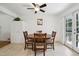 Cozy dining area featuring tile floor, white walls, ceiling fan and an exit to the outdoor area at 2251 Braun Dr, Golden, CO 80401