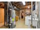 Basement laundry room with washer, dryer, utility sink, water heater, and storage at 2251 Braun Dr, Golden, CO 80401