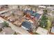 Aerial view of brick home featuring mature trees, detached garage, backyard deck and hot tub at 841 Niagara St, Denver, CO 80220