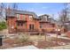 Spacious backyard featuring a wooden deck, upper level balconies, and a relaxing hot tub at 841 Niagara St, Denver, CO 80220