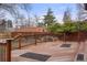 Wood deck with view of backyard, landscaping, and wooded fence line at 841 Niagara St, Denver, CO 80220
