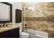 Bathroom featuring tiled shower, vanity with granite counter, and a mosaic accent at 841 Niagara St, Denver, CO 80220