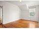 Bright bedroom featuring hardwood floors, neutral walls, and a window providing natural light at 841 Niagara St, Denver, CO 80220