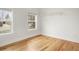 Empty bedroom with hardwood floors, large windows, and white walls at 841 Niagara St, Denver, CO 80220