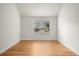 Neutral bedroom featuring hardwood floors and a large window offering neighborhood views at 841 Niagara St, Denver, CO 80220