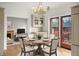 Bright dining room featuring a round table set for four, with a view of the living room and outdoor deck at 841 Niagara St, Denver, CO 80220