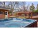 Backyard features a built-in hot tub with waterfalls, wood deck, and privacy fence at 841 Niagara St, Denver, CO 80220