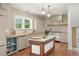 Farmhouse kitchen featuring a marble-top island, custom cabinets, butcher block countertops, and stainless steel appliances at 841 Niagara St, Denver, CO 80220