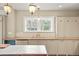 Bright kitchen featuring custom cabinets, light fixtures, marble countertops, and stainless steel appliances at 841 Niagara St, Denver, CO 80220