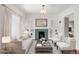 Bright living room featuring a decorative fireplace, built-in shelving, and neutral-toned furniture at 841 Niagara St, Denver, CO 80220