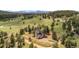 Stunning aerial view of the home and surroundings, with a paved driveway and a three car garage at 25350 Ridge Way, Golden, CO 80401