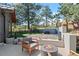 Landscaped backyard featuring a fire pit, seating area, and views of the surrounding trees at 25350 Ridge Way, Golden, CO 80401