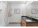 Clean bathroom with double sinks, patterned tile flooring, and shower with floral curtain at 25350 Ridge Way, Golden, CO 80401