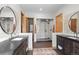 Bright bathroom featuring a glass enclosed shower, tile floors, double vanity sinks, and a patterned rug at 25350 Ridge Way, Golden, CO 80401