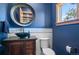 Stylish powder room featuring dark blue walls and a dark wood cabinet with a bowl sink at 25350 Ridge Way, Golden, CO 80401