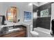 Modern bathroom with a large mirror, sleek vanity, and a bathtub with a shower at 25350 Ridge Way, Golden, CO 80401
