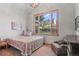 Bedroom with a vaulted ceiling, bright window with a nice view, and a cozy chair at 25350 Ridge Way, Golden, CO 80401
