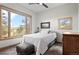 Cozy bedroom with large windows offering scenic views of the surrounding landscape at 25350 Ridge Way, Golden, CO 80401