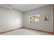 Cozy bedroom featuring soft carpeting, natural wood trim, and a view of the outdoors at 25350 Ridge Way, Golden, CO 80401