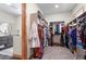 Spacious walk-in closet with custom shelving, hanging rods, and a glimpse of the bathroom at 25350 Ridge Way, Golden, CO 80401