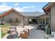 Rear exterior view displaying a concrete patio with outdoor furniture, a fire pit, and backyard at 25350 Ridge Way, Golden, CO 80401