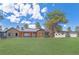 Stunning single-story home featuring stone accents, wood trim, metal roof, large lawn and mature landscaping at 25350 Ridge Way, Golden, CO 80401