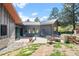 Rear exterior showcasing a concrete patio with outdoor seating, a fire pit, and lush landscaping at 25350 Ridge Way, Golden, CO 80401