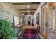 Inviting foyer with exposed wood beams, a brick wall, hardwood floors, and elegant decor at 25350 Ridge Way, Golden, CO 80401