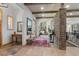 Spacious entryway featuring a brick accent wall, hardwood floors, and a view into the living area at 25350 Ridge Way, Golden, CO 80401