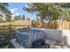 Outdoor hot tub surrounded by a wooden fence and trees at 25350 Ridge Way, Golden, CO 80401