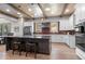 Bright kitchen with stainless steel appliances, granite counters and island seating at 25350 Ridge Way, Golden, CO 80401