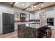 Open kitchen with stainless steel appliances, granite counters, and center island with seating at 25350 Ridge Way, Golden, CO 80401