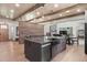 This modern kitchen boasts an island with seating, brick accent wall, and open floor plan at 25350 Ridge Way, Golden, CO 80401