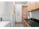 Functional laundry room with modern appliances, storage, and a sink at 25350 Ridge Way, Golden, CO 80401