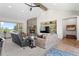 Well-lit living room with a stone fireplace and built-in media shelving at 25350 Ridge Way, Golden, CO 80401