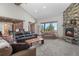 Cozy living room with a stone fireplace, large windows, and comfortable seating at 25350 Ridge Way, Golden, CO 80401