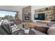 Comfortable living room featuring a stone fireplace and built in shelving at 25350 Ridge Way, Golden, CO 80401