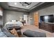 Spacious main bedroom with tray ceilings, a ceiling fan and a seating area at 25350 Ridge Way, Golden, CO 80401