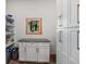 Walk-in pantry featuring white cabinets, granite counters and custom window at 25350 Ridge Way, Golden, CO 80401