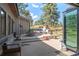 Outdoor patio with concrete, comfortable seating, dining table, and views of the surrounding landscape at 25350 Ridge Way, Golden, CO 80401