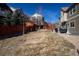Spacious backyard featuring a patio with outdoor seating and mature trees, providing ample space for activities at 1665 Avery Way, Castle Rock, CO 80109
