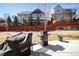 Backyard view of the home with mature trees, a grill, and a patio area for outdoor relaxation and cooking at 1665 Avery Way, Castle Rock, CO 80109