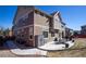 Exterior view of the home with a large patio, outdoor dining set, and manicured landscaping for outdoor living at 1665 Avery Way, Castle Rock, CO 80109