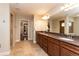 Bathroom with double vanity, large mirror and a view of the shower and closet at 1665 Avery Way, Castle Rock, CO 80109