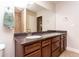 Bathroom features a single sink vanity with a dark countertop, a towel rack, and a tiled shower at 1665 Avery Way, Castle Rock, CO 80109
