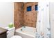 Cozy bathroom features a tiled shower/tub, a toilet, and a shower curtain with a butterfly design at 1665 Avery Way, Castle Rock, CO 80109