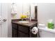 Modern bathroom with dark cabinets, granite countertop, and stainless steel fixtures at 1665 Avery Way, Castle Rock, CO 80109