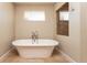 Bright and airy bathroom featuring a luxurious stand alone tub and tile flooring at 1665 Avery Way, Castle Rock, CO 80109